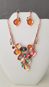 Rose colored Necklace & Earring Set with multi colored resin drops in peace lily type shapes. Round and Oval CZ's. Post Earring with peace lily drops and round CZ's 18 in snake chain with 4 in extension .