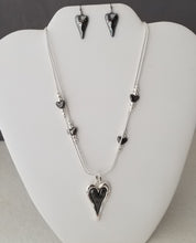 Double strand Necklace with Black & Silver heart Pendant with small heat stations with silver beads. 18 in Necklace with 2 in extension. Shepard hook earrings