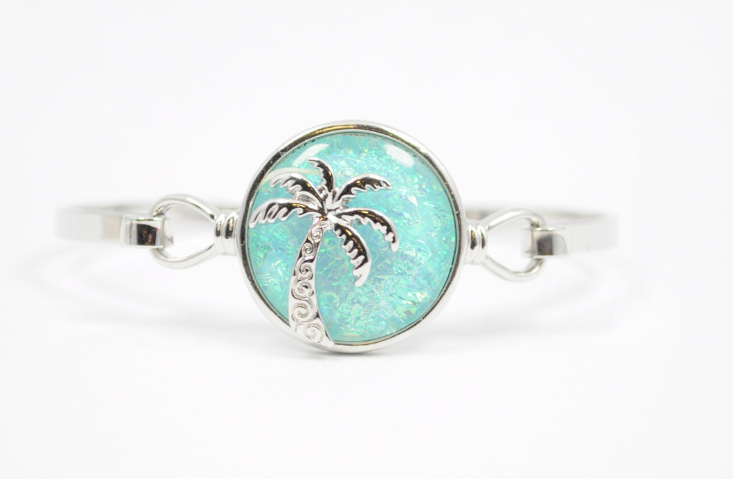 Bracelet with Palm Tree design with beautiful aqua resin circle. Fits most average size wrists.(7-7.75) 