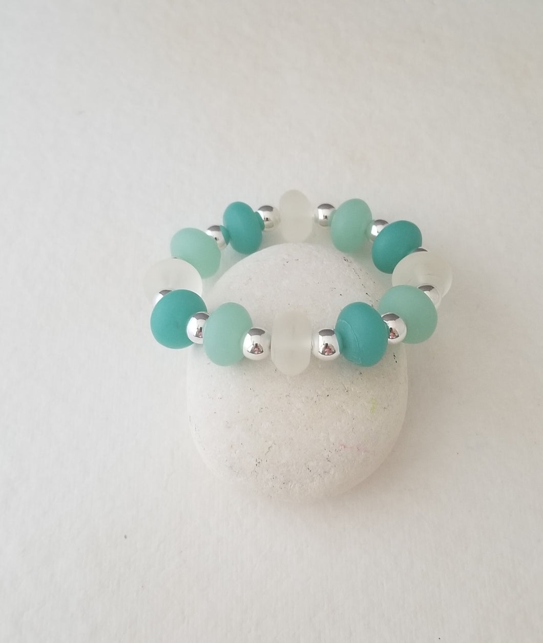 Sea Glass stretch bracelet with frosted clear beads, Light aqua and dark aqua sea glass beads with silver spacer beads. Fits wrist 7in and up