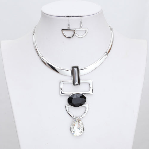 Necklace with CZ's in various shapes rectangle oval and teardrop. Silver color base with half circle earrings. Beautiful statement piece