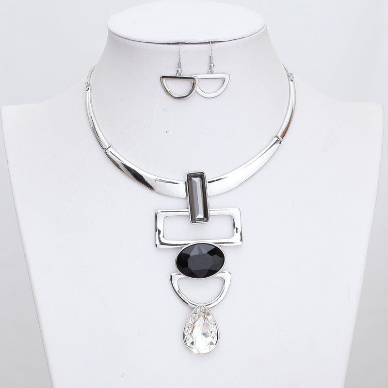 Necklace with CZ's in various shapes rectangle oval and teardrop. Silver color base with half circle earrings. Beautiful statement piece