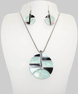 Beautiful Necklace & Earrings circular pattern with a 18 inch chain and 2 inch extender The design is a round circle of silver color shapes and beautiful shimmering light blue resin resembling the beautiful waters of the Sea