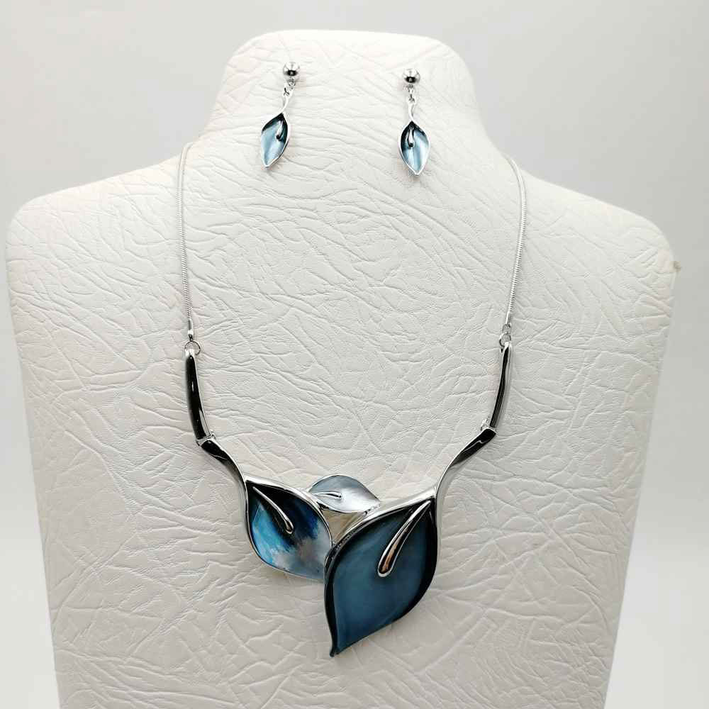 Necklace and earring set with leaf pattern shades of blue color through out the pattern. Silver colored base, post earrings are dangle leaf.  Necklace is 16 inches with a 3 inch extension.