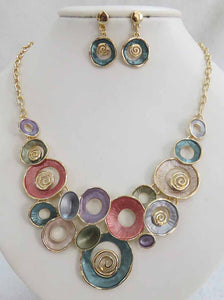 Beautiful circles of blue, grey, coral, taupe, with gold colored swirls and chain. Earrings included. 18 inches with 2 inch extender