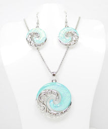 Beautiful Necklace & Earrings Wave Swirl with a 18 inch chain and 2 inch extender It shimmering light blue resin resembling the beautiful waters of the Sea