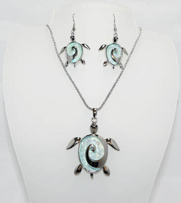 Beautiful Necklace & Earrings Turtle Set with a 18 inch chain and 2 inch extender It shimmering light blue resin resembling the beautiful waters of the Sea